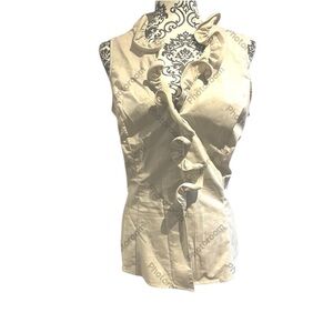 Stunning sleeveless cream blouse with floral motif neckline.